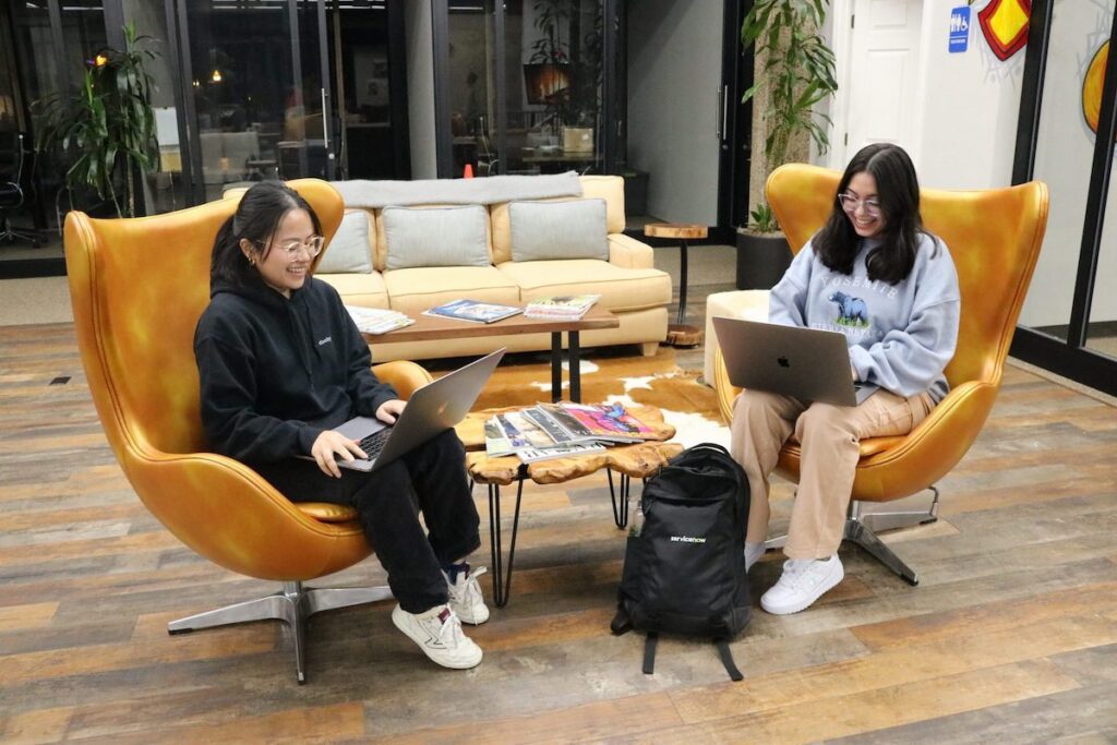 Two women working on laptop computers.